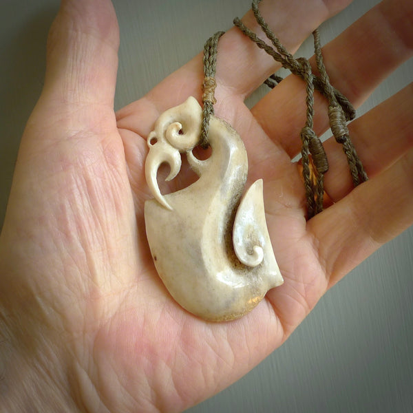 Hand made deer antler manaia pendant. Hand carved by NZ Pacific. Manaia carved from deer antler pendant for sale online. Delivered to you on an adjustable cord.