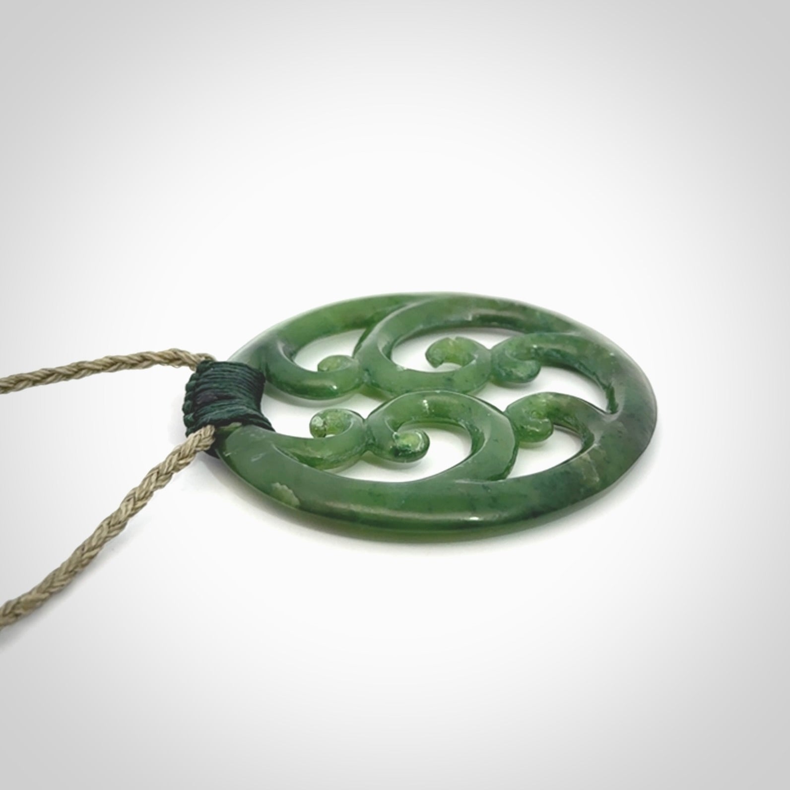 This picture shows a large, rolling koru design with six koru florets unfurling from the centre.