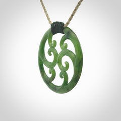 This picture shows a large, rolling koru design with six koru florets unfurling from the centre.