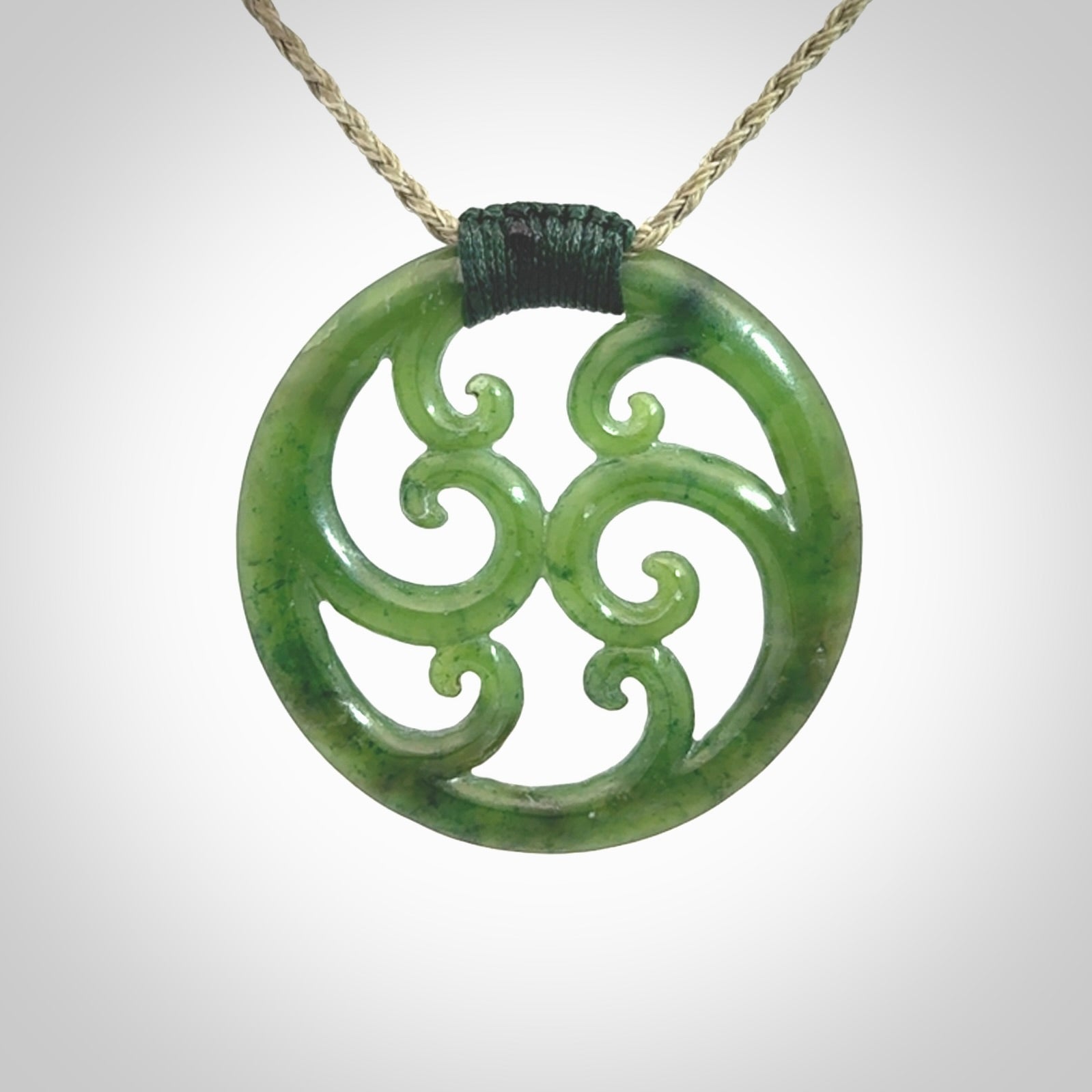 This picture shows a large, rolling koru design with six koru florets unfurling from the centre.