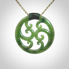 This picture shows a large, rolling koru design with six koru florets unfurling from the centre.