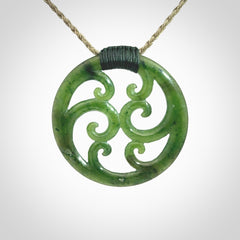 This picture shows a large, rolling koru design with six koru florets unfurling from the centre.