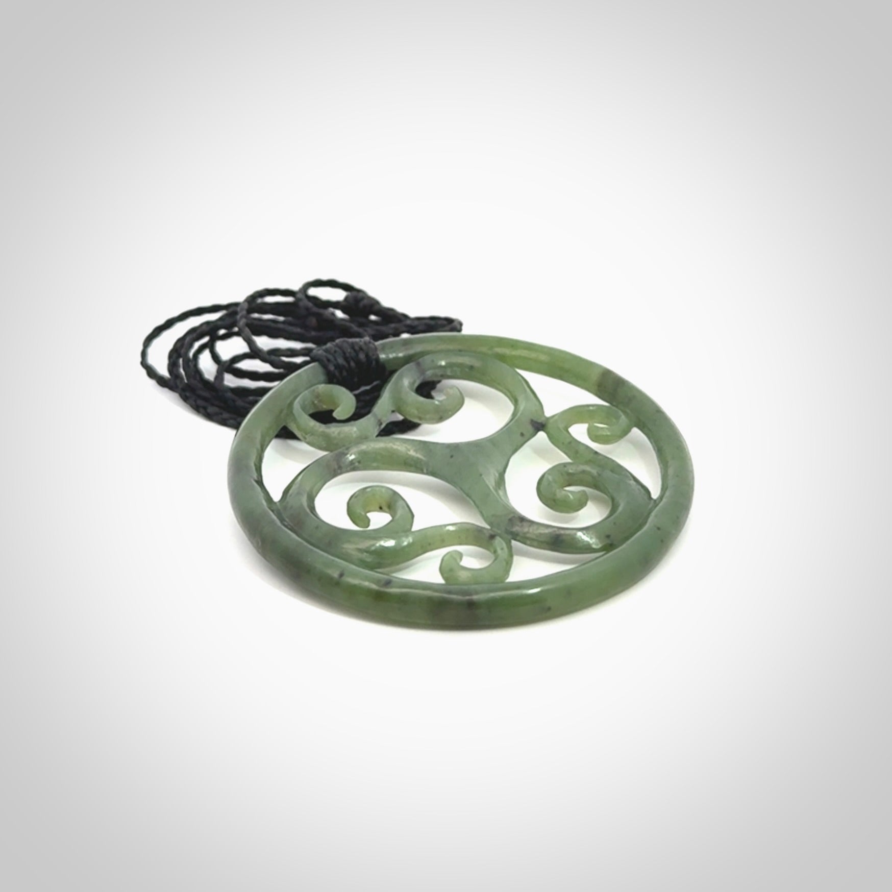 This picture shows a large, rolling koru design with six koru florets unfurling from the centre.