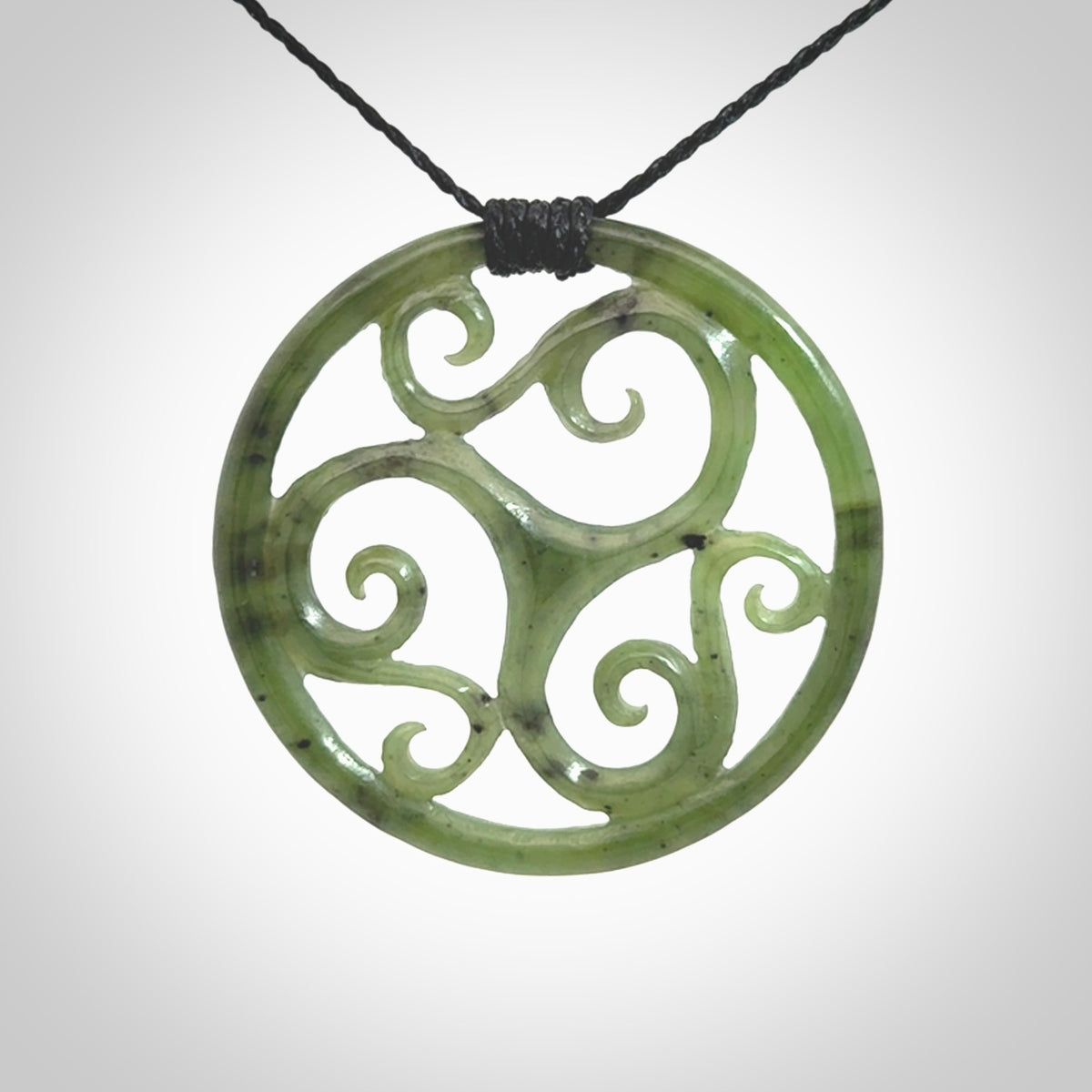 This picture shows a large, rolling koru design with six koru florets unfurling from the centre.