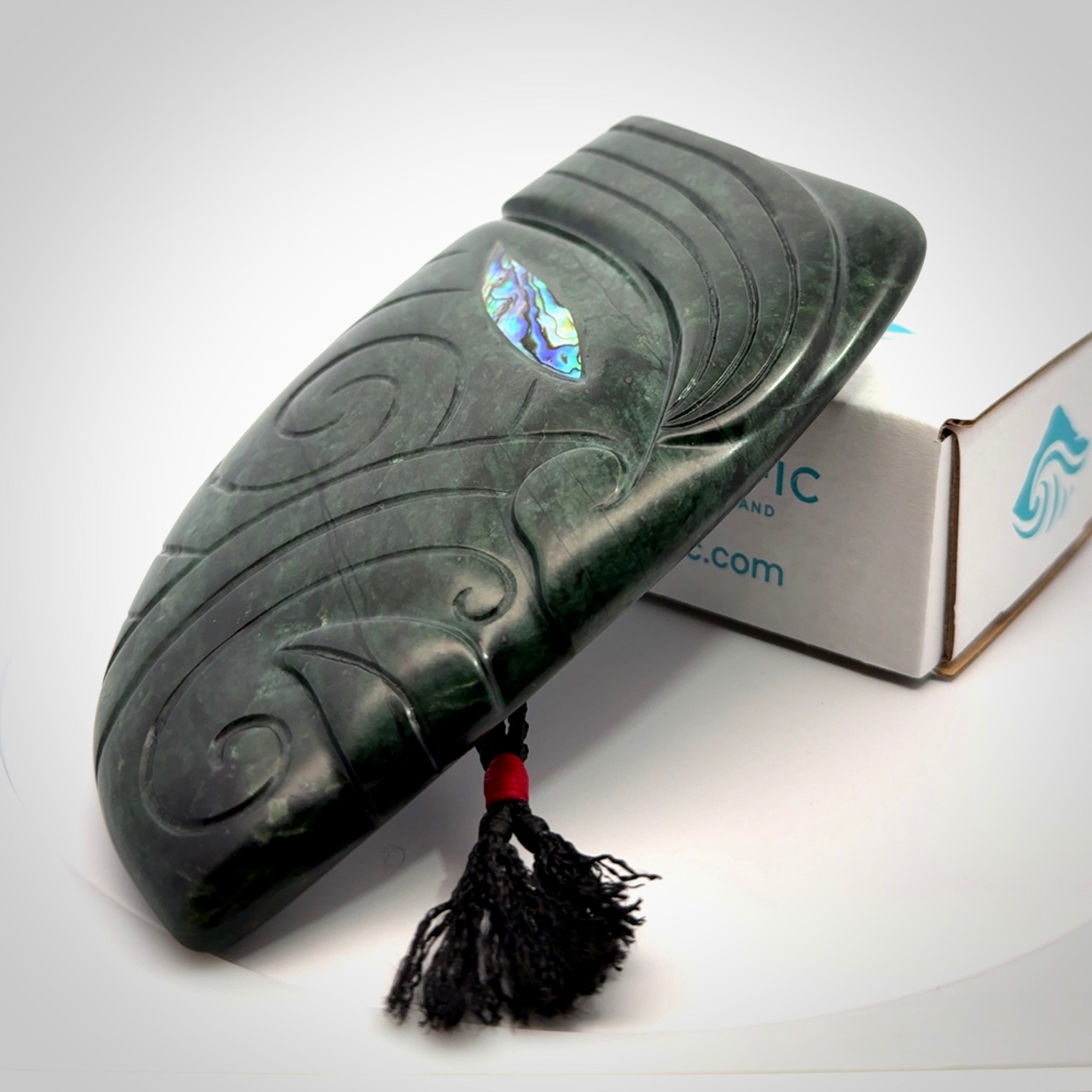 This is a large hand carved New Zealand Jade chief head display art. It is made from New Zealand Jade and Paua shell.