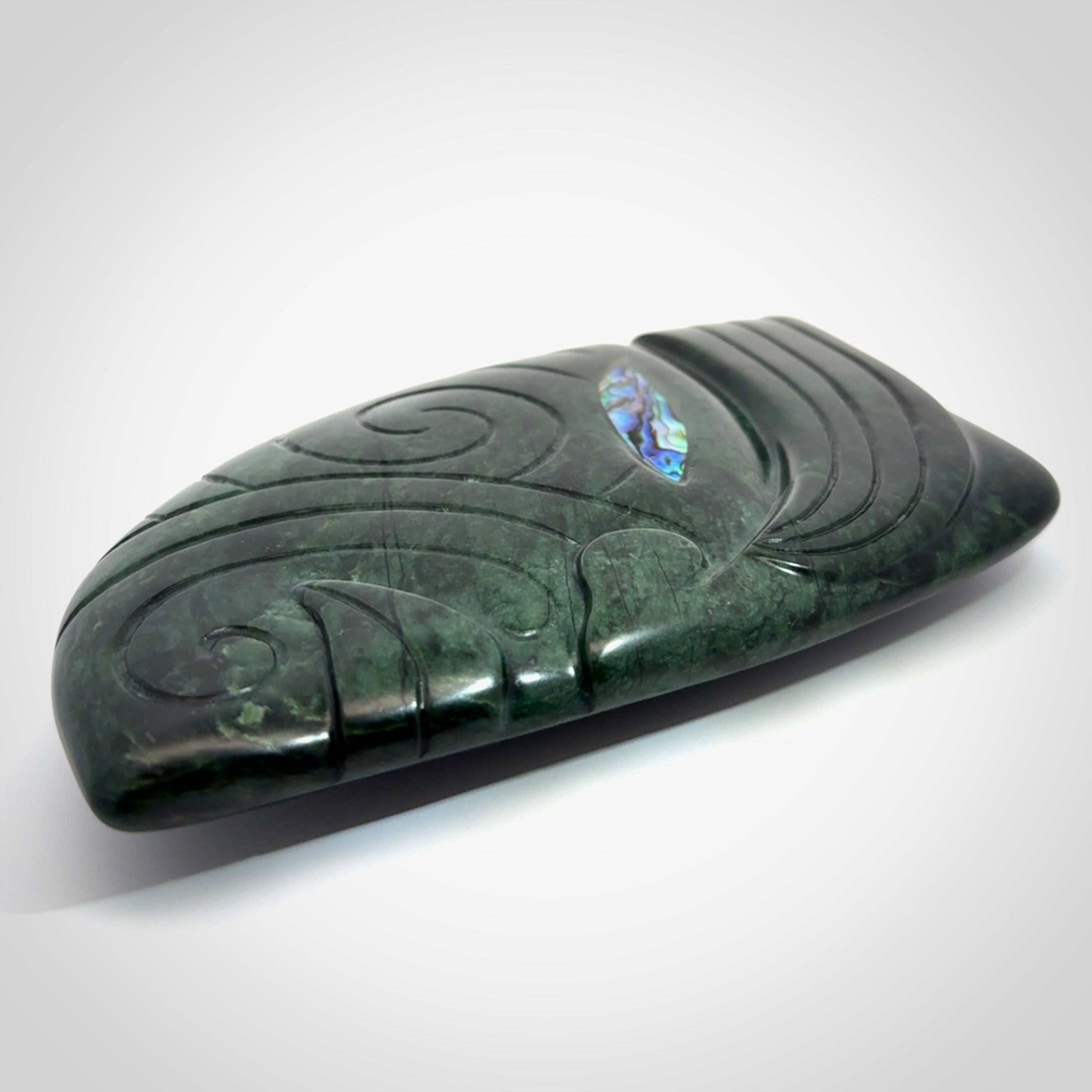 This is a large hand carved New Zealand Jade chief head display art. It is made from New Zealand Jade and Paua shell.