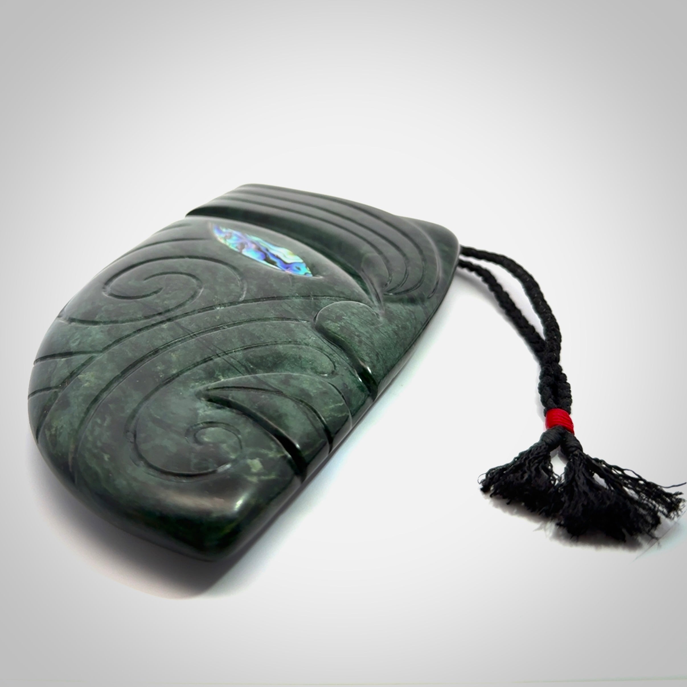 This is a large hand carved New Zealand Jade chief head display art. It is made from New Zealand Jade and Paua shell.