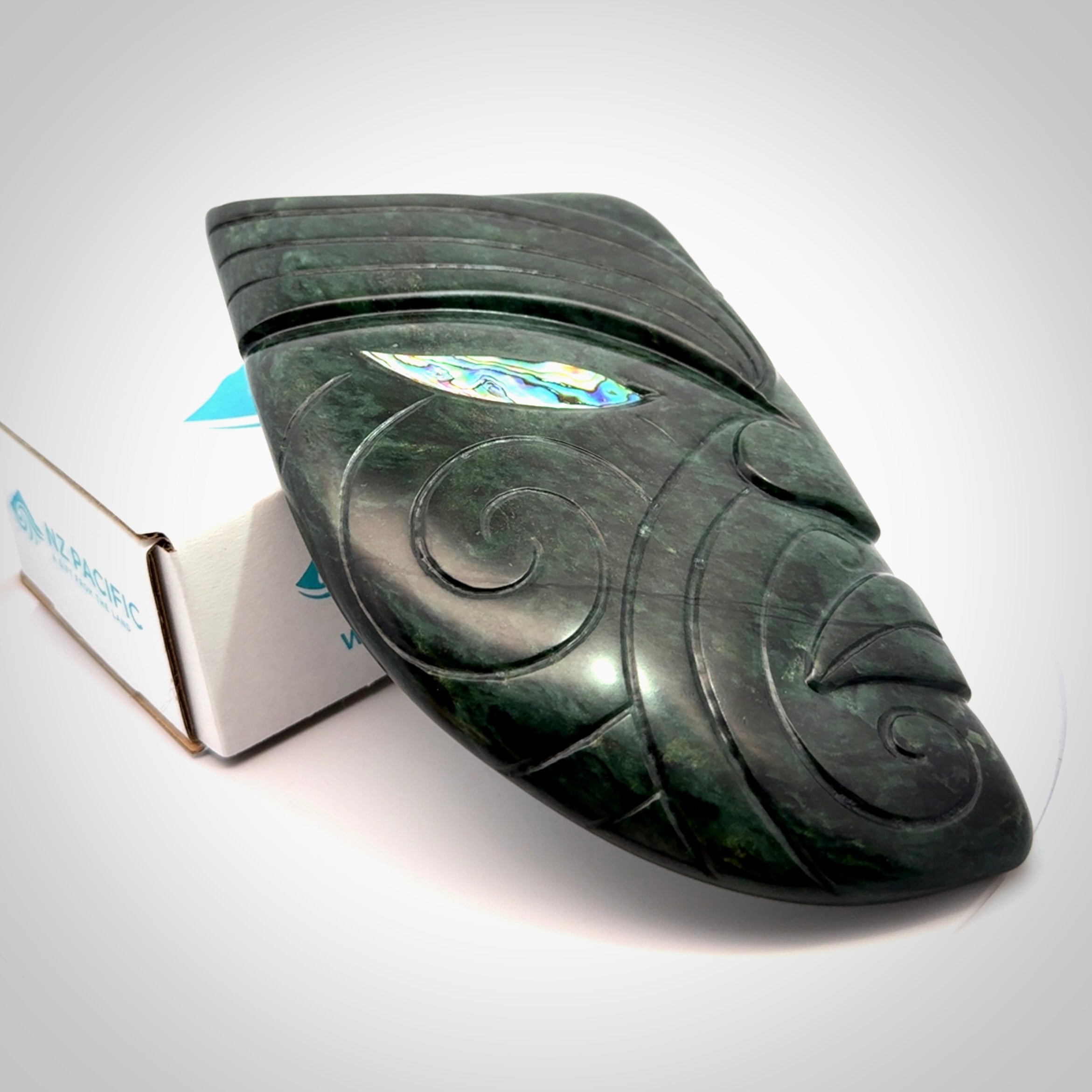 This is a large hand carved New Zealand Jade chief head display art. It is made from New Zealand Jade and Paua shell.