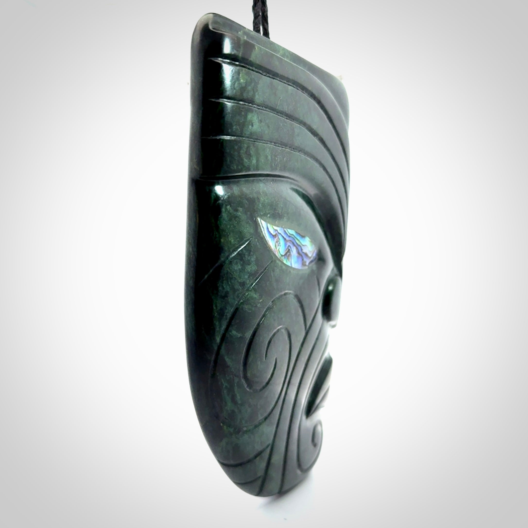 This is a large hand carved New Zealand Jade chief head display art. It is made from New Zealand Jade and Paua shell.