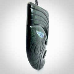 This is a large hand carved New Zealand Jade chief head display art. It is made from New Zealand Jade and Paua shell.