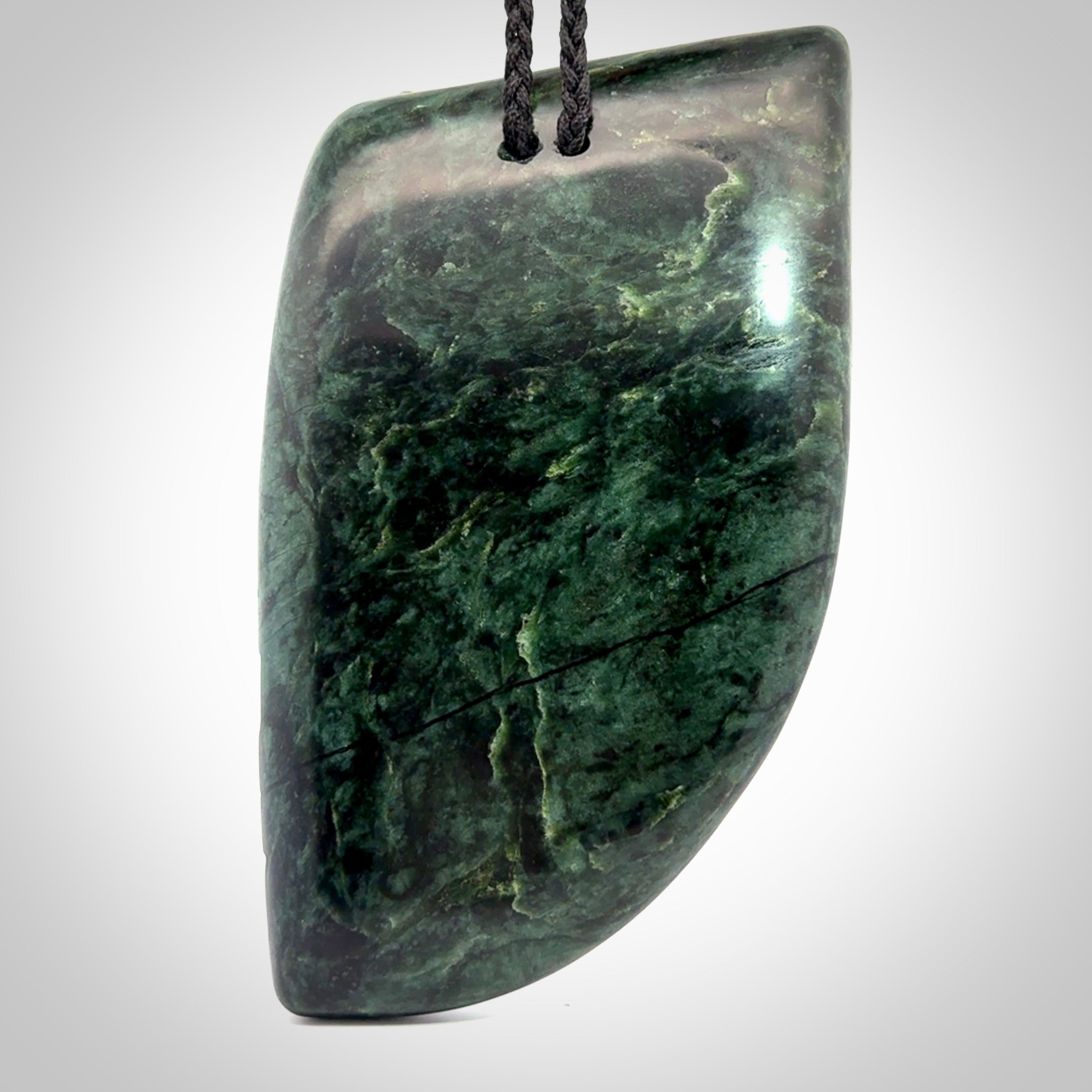 This is a large hand carved New Zealand Jade chief head display art. It is made from New Zealand Jade and Paua shell.