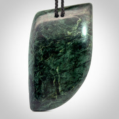 This is a large hand carved New Zealand Jade chief head display art. It is made from New Zealand Jade and Paua shell.