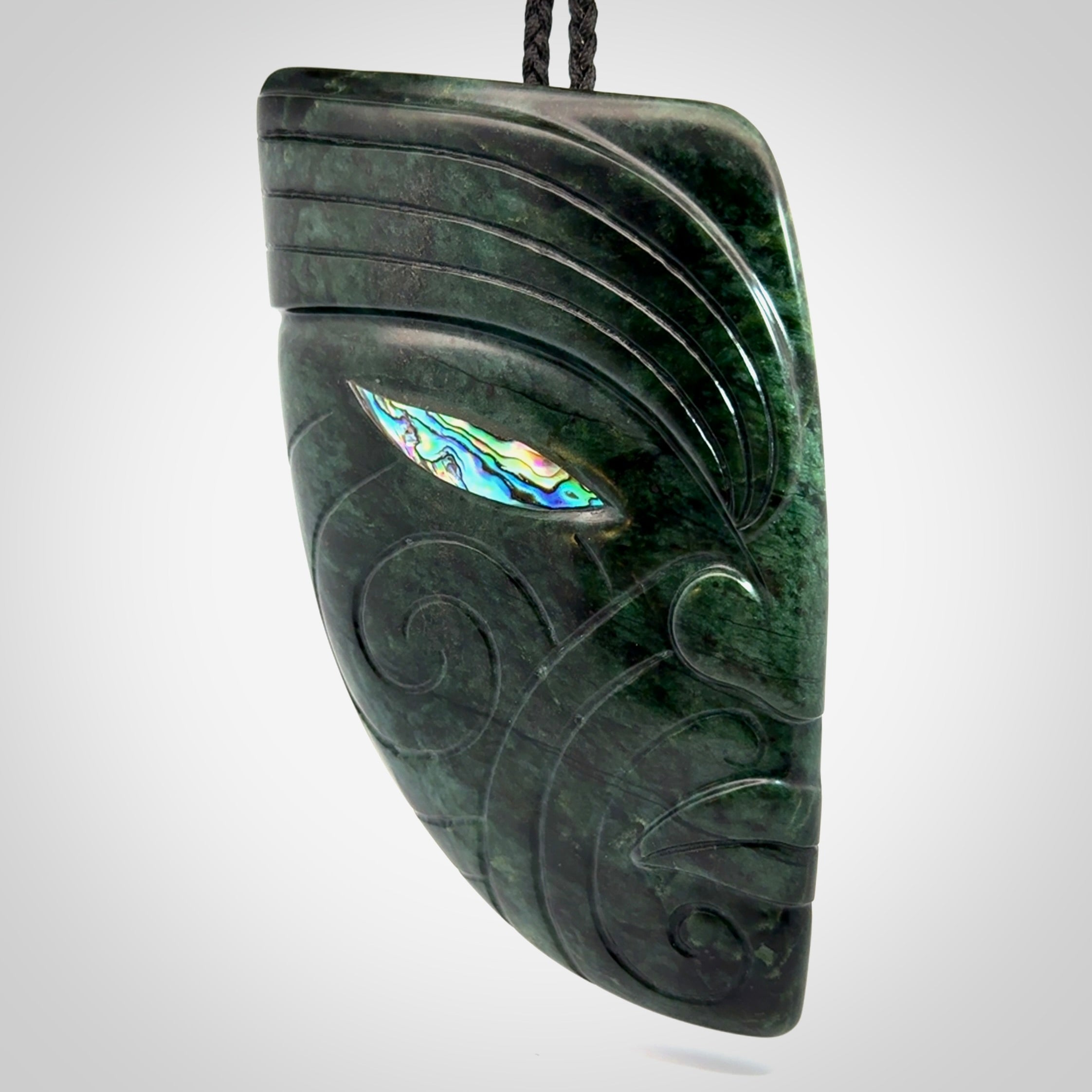 This is a large hand carved New Zealand Jade chief head display art. It is made from New Zealand Jade and Paua shell.