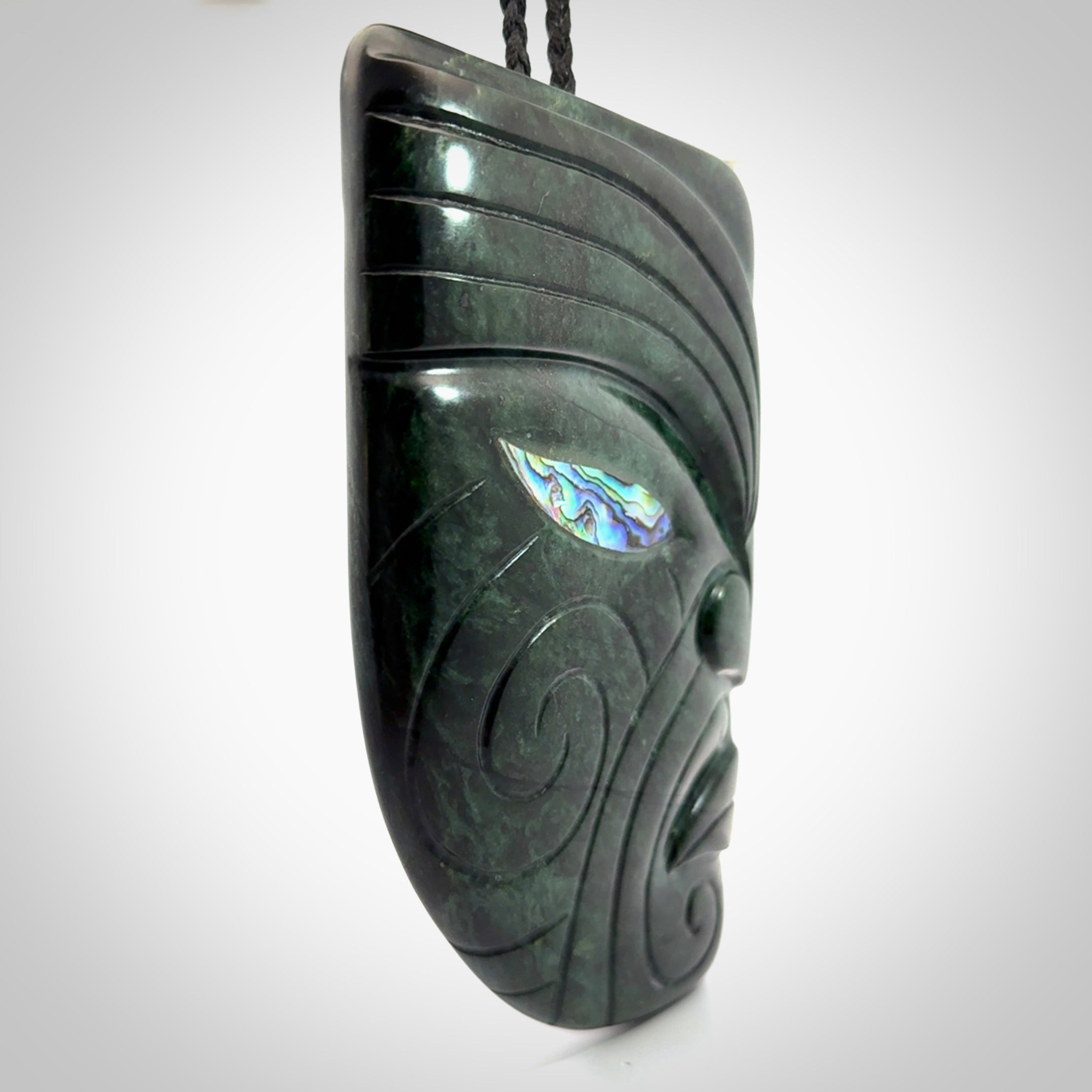 This is a large hand carved New Zealand Jade chief head display art. It is made from New Zealand Jade and Paua shell.