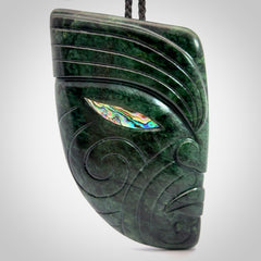 This is a large hand carved New Zealand Jade chief head display art. It is made from New Zealand Jade and Paua shell.