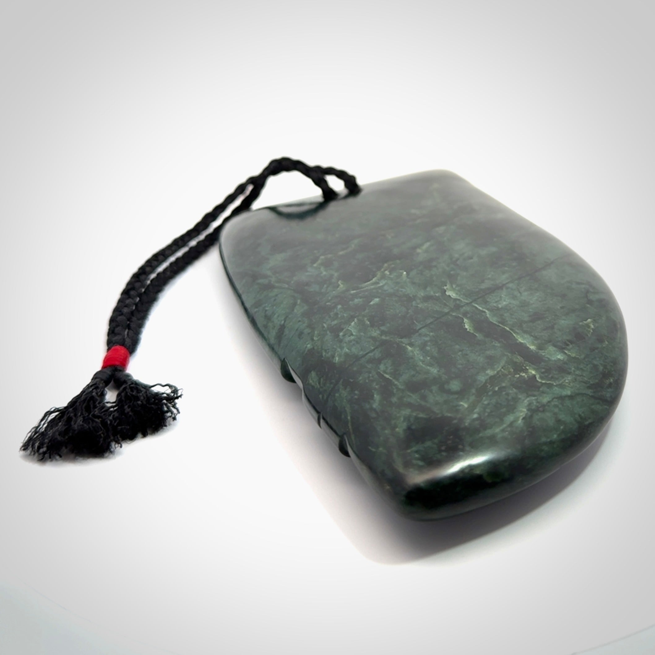 This is a large hand carved New Zealand Jade chief head display art. It is made from New Zealand Jade and Paua shell.