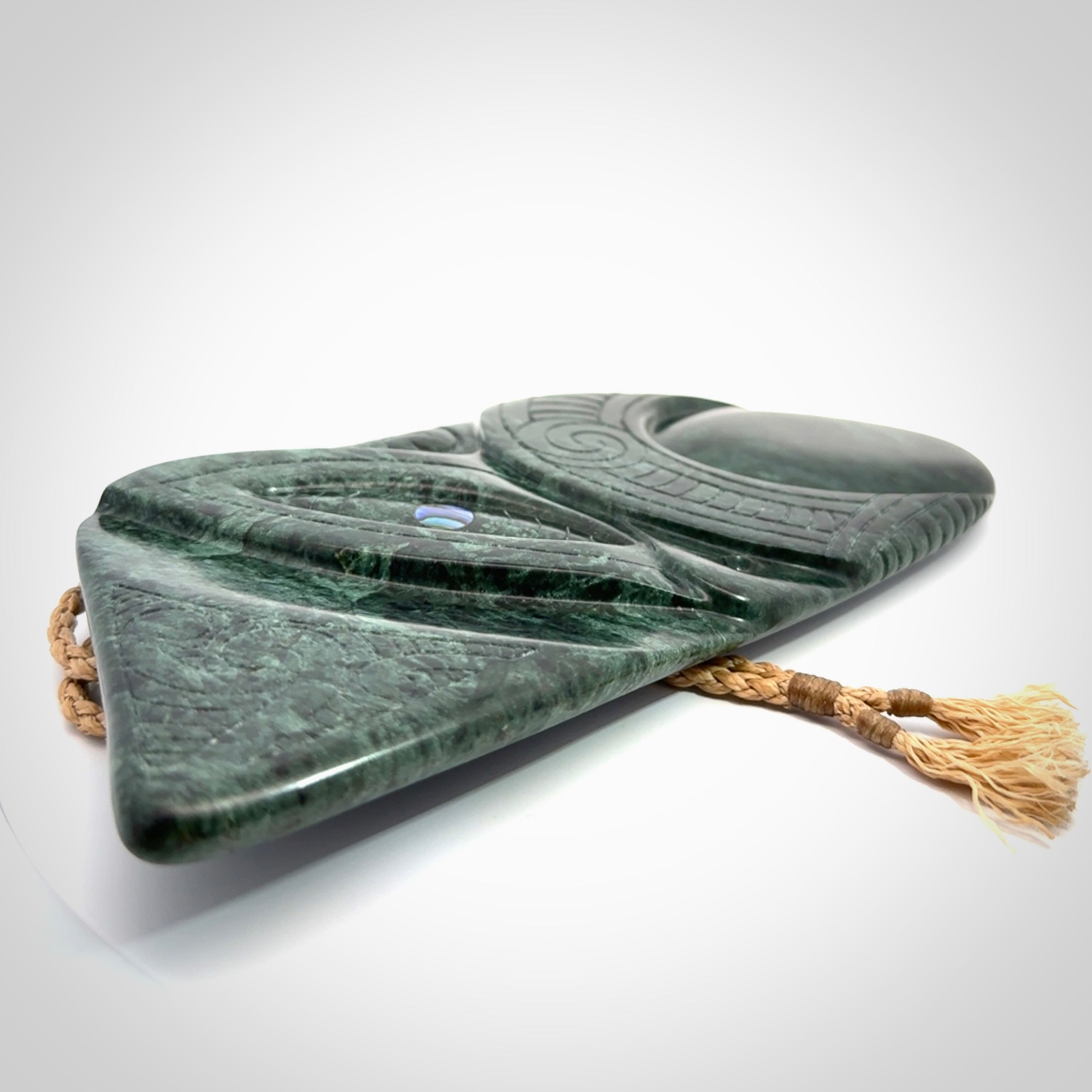 This is a large hand carved New Zealand Jade wheku pendant. It is made from New Zealand Jade and Paua shell.