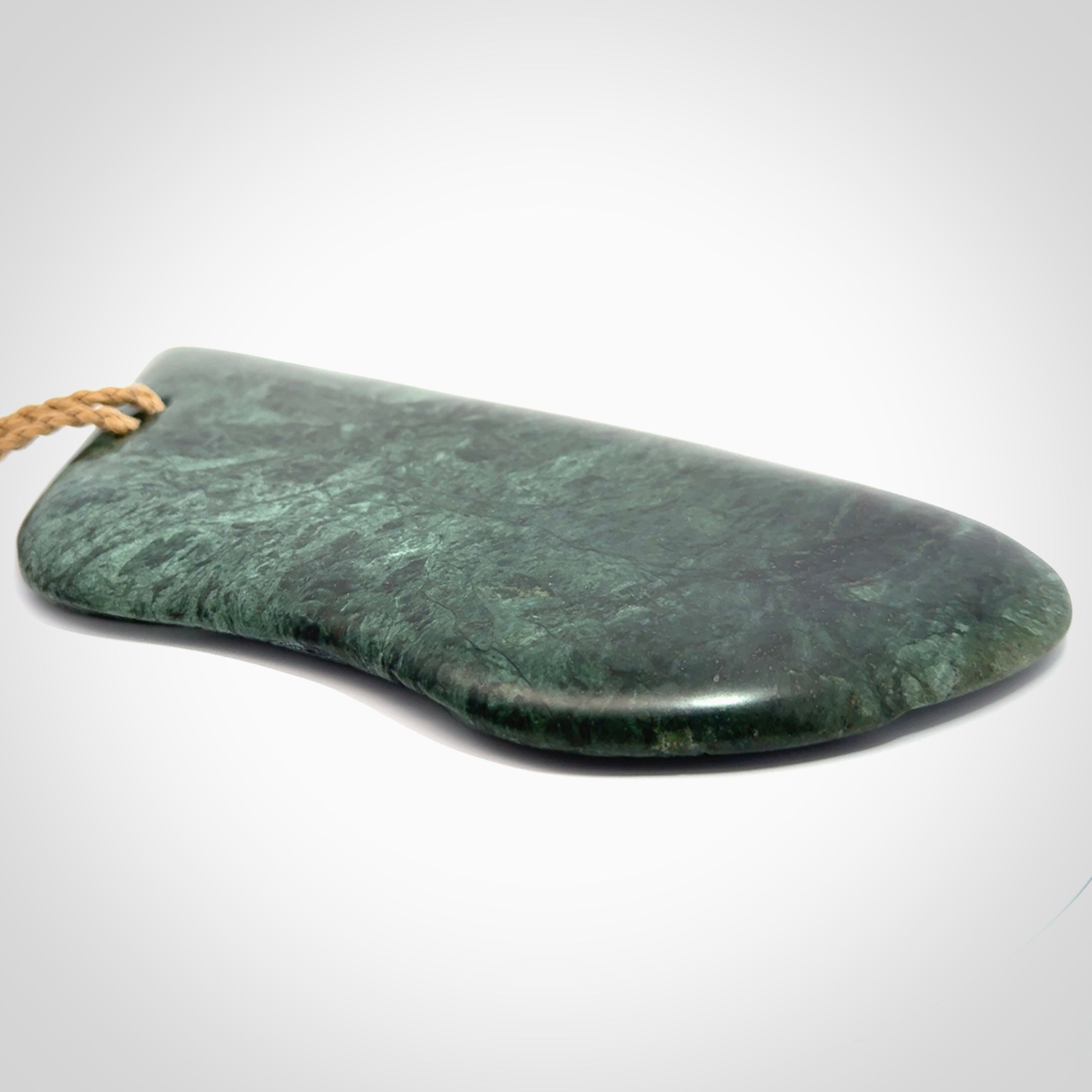 This is a large hand carved New Zealand Jade wheku pendant. It is made from New Zealand Jade and Paua shell.
