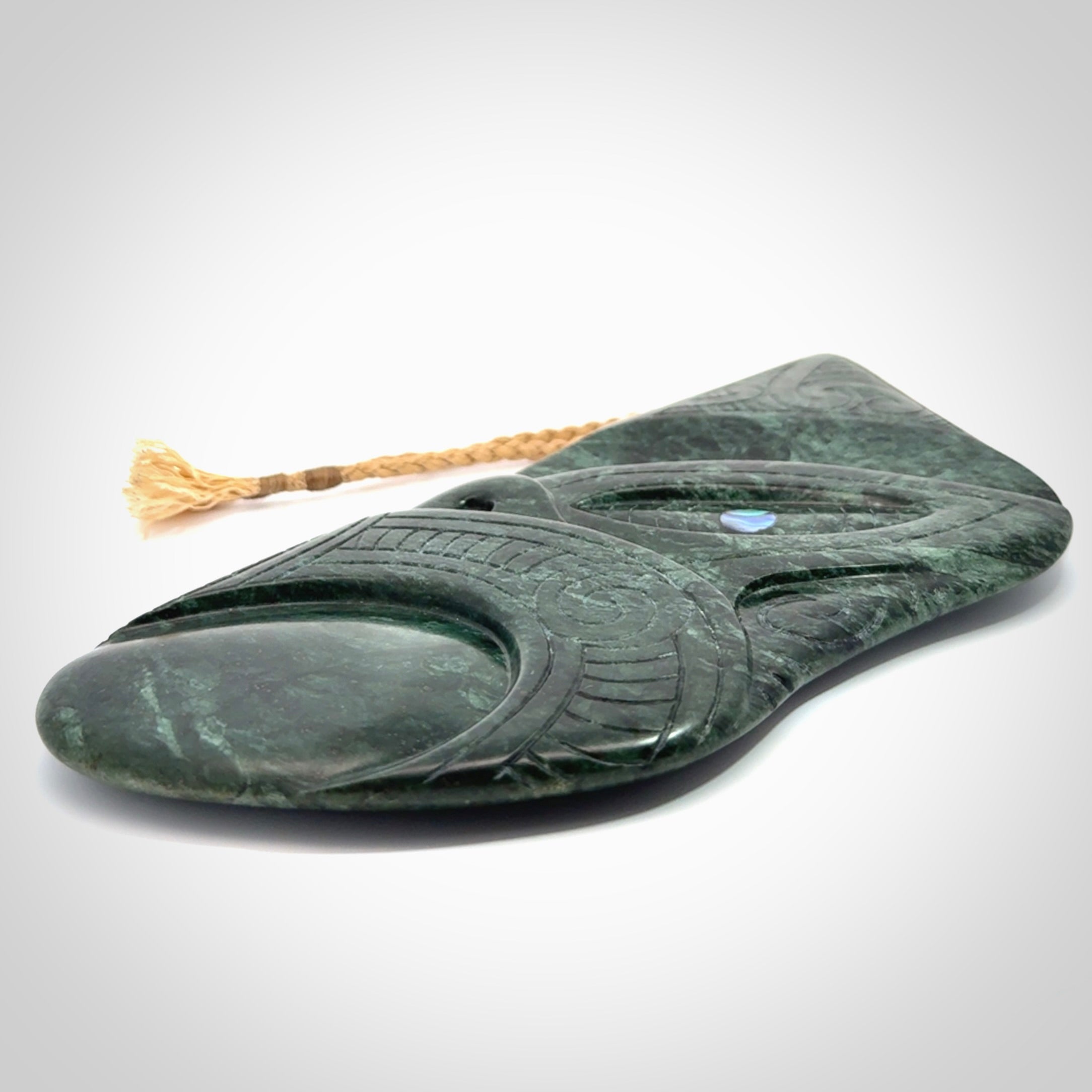 This is a large hand carved New Zealand Jade wheku pendant. It is made from New Zealand Jade and Paua shell.