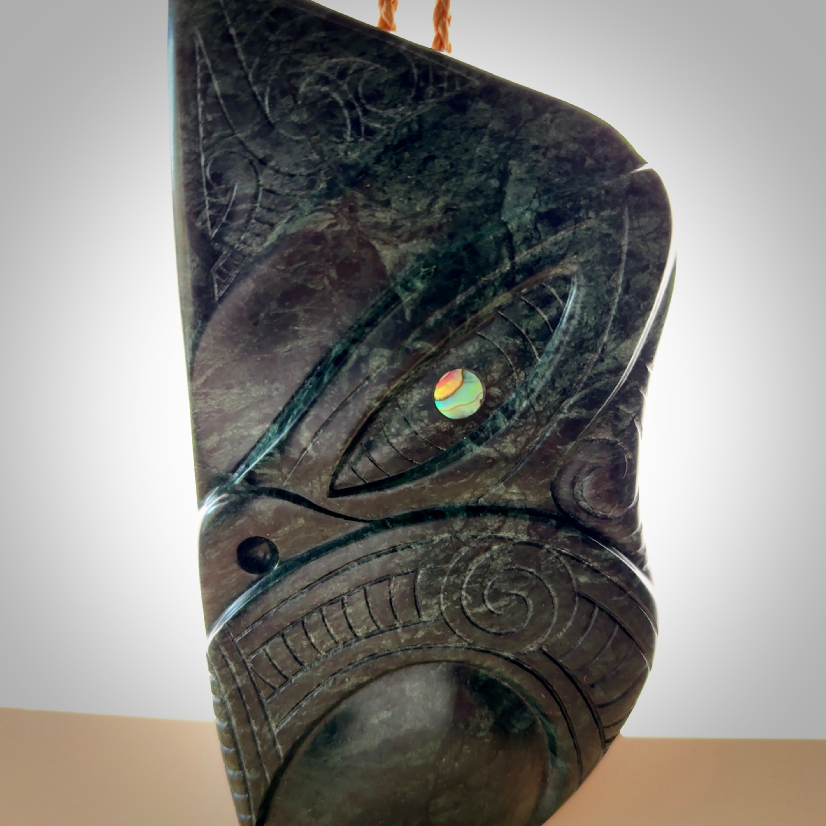 This is a large hand carved New Zealand Jade wheku pendant. It is made from New Zealand Jade and Paua shell.