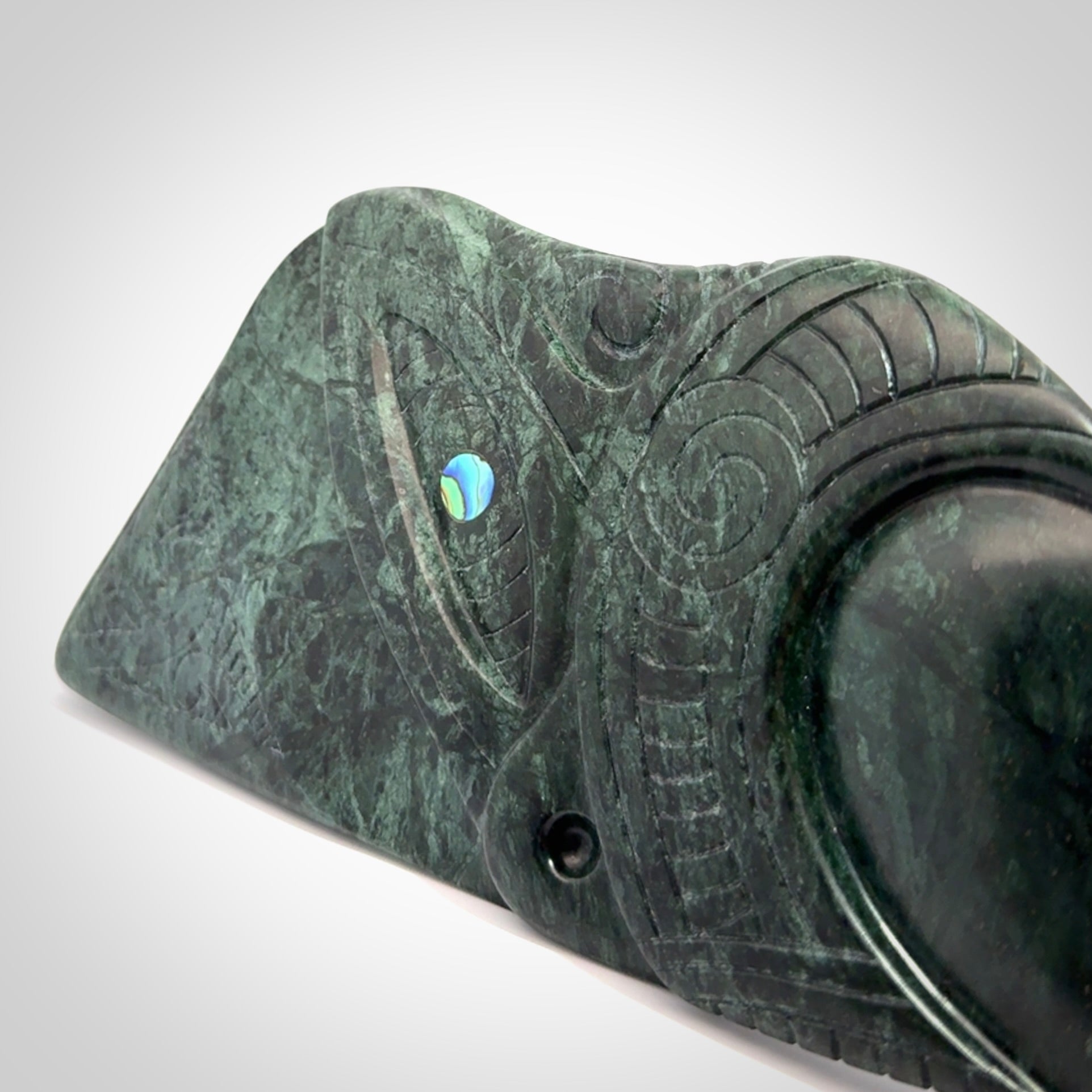 This is a large hand carved New Zealand Jade wheku pendant. It is made from New Zealand Jade and Paua shell.