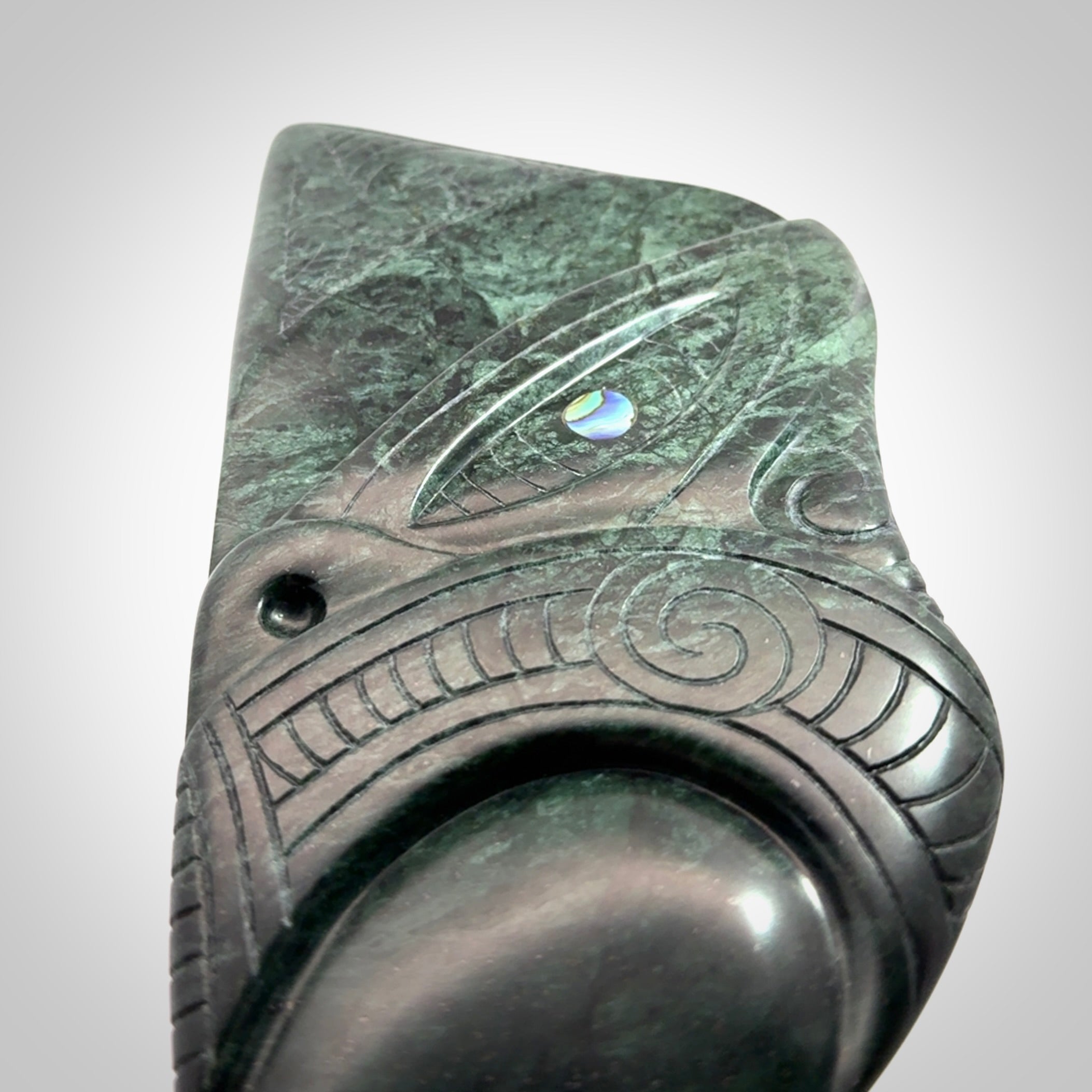This is a large hand carved New Zealand Jade wheku pendant. It is made from New Zealand Jade and Paua shell.