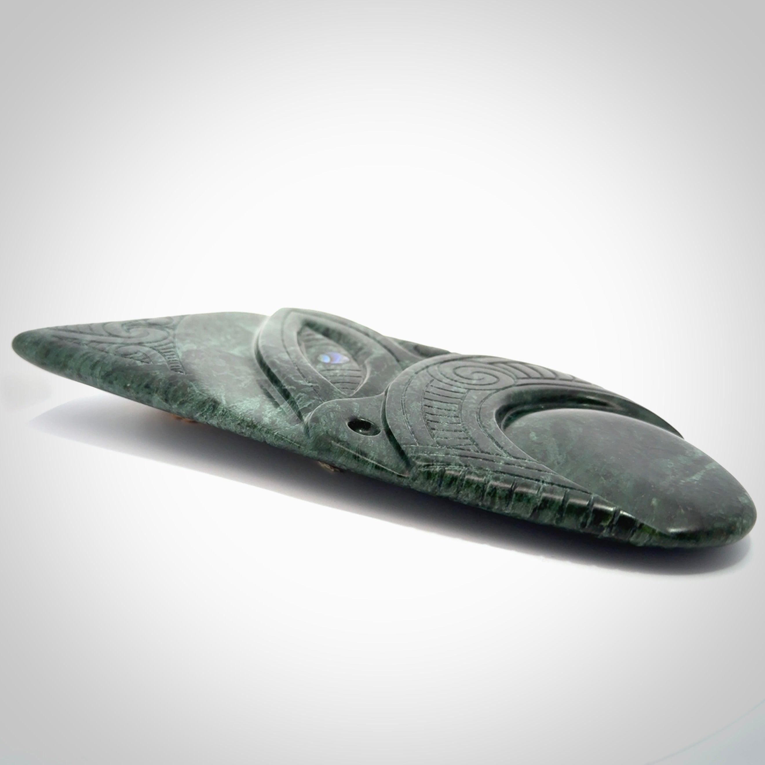 This is a large hand carved New Zealand Jade wheku pendant. It is made from New Zealand Jade and Paua shell.
