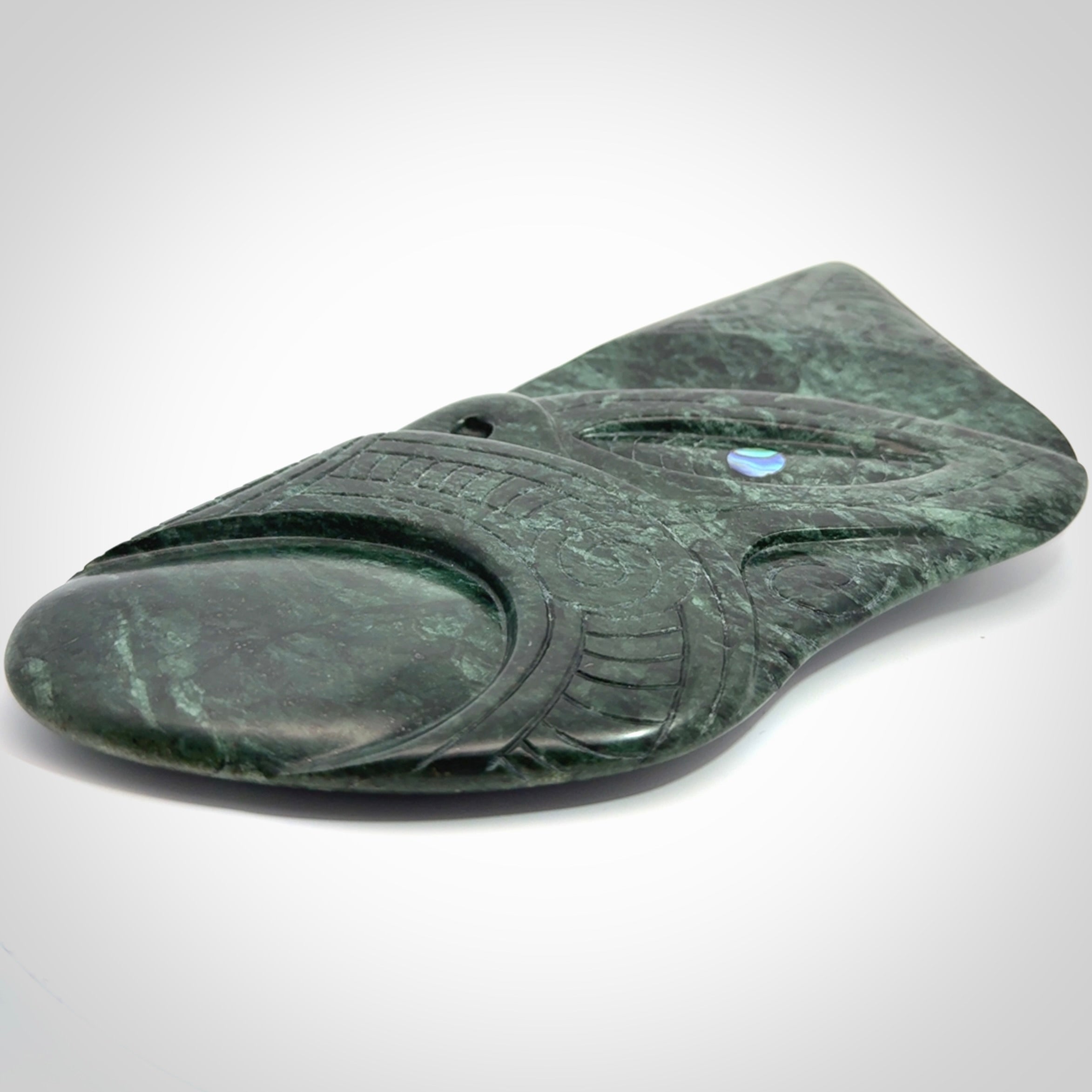 This is a large hand carved New Zealand Jade wheku pendant. It is made from New Zealand Jade and Paua shell.