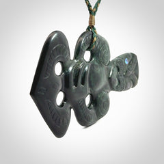 This is a large hand carved New Zealand Jade tiki pendant. It is made from New Zealand Jade and Paua shell.