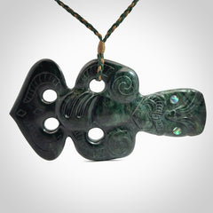 This is a large hand carved New Zealand Jade tiki pendant. It is made from New Zealand Jade and Paua shell.