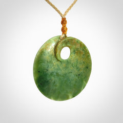 Hand carved New Zealand Flower Jade disc pendant