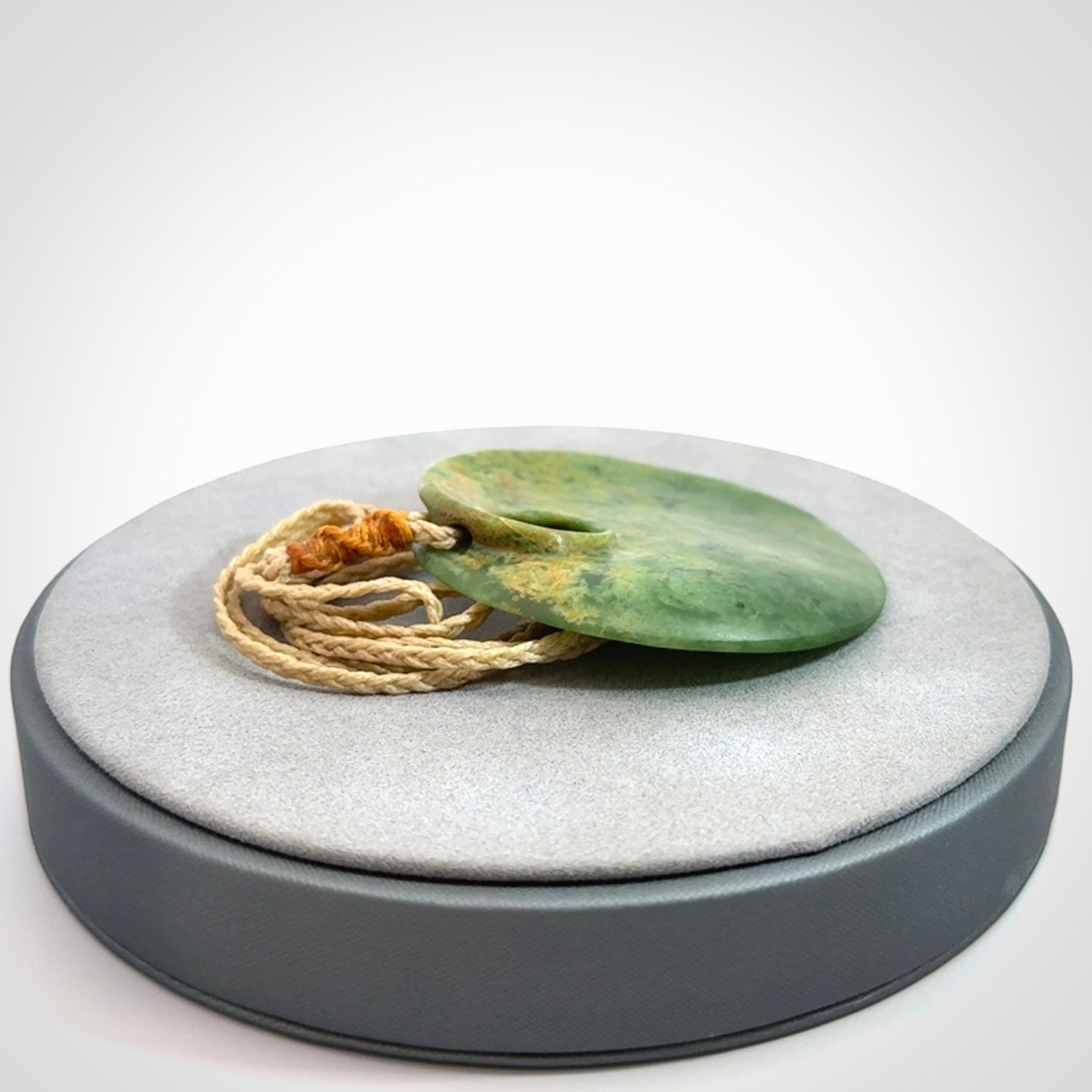 Hand carved New Zealand Flower Jade disc pendant