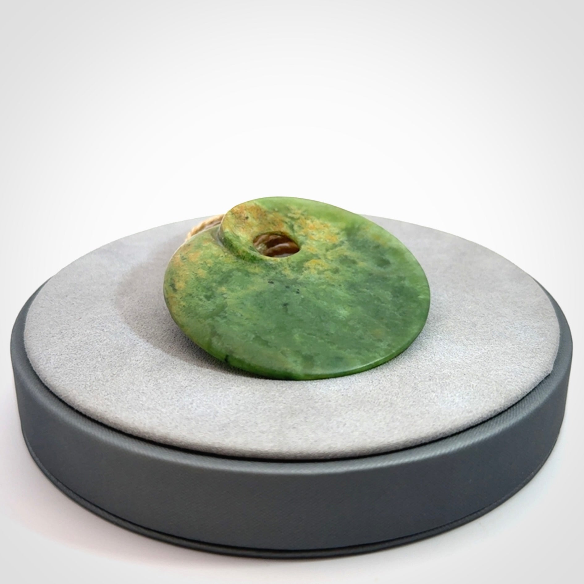 Hand carved New Zealand Flower Jade disc pendant
