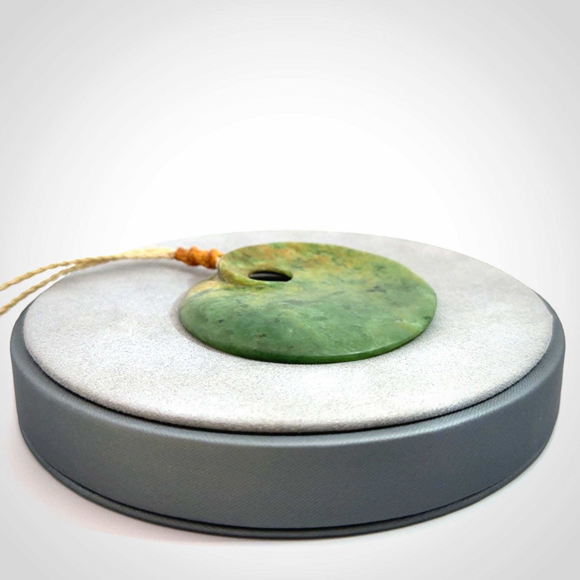 Hand carved New Zealand Flower Jade disc pendant