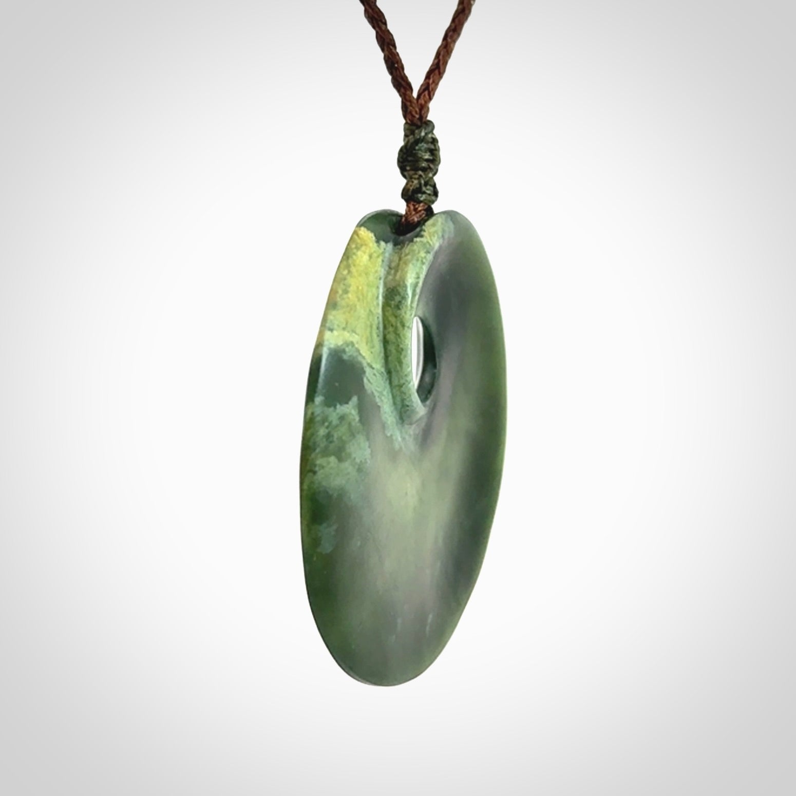 Hand carved New Zealand Jade disc pendant