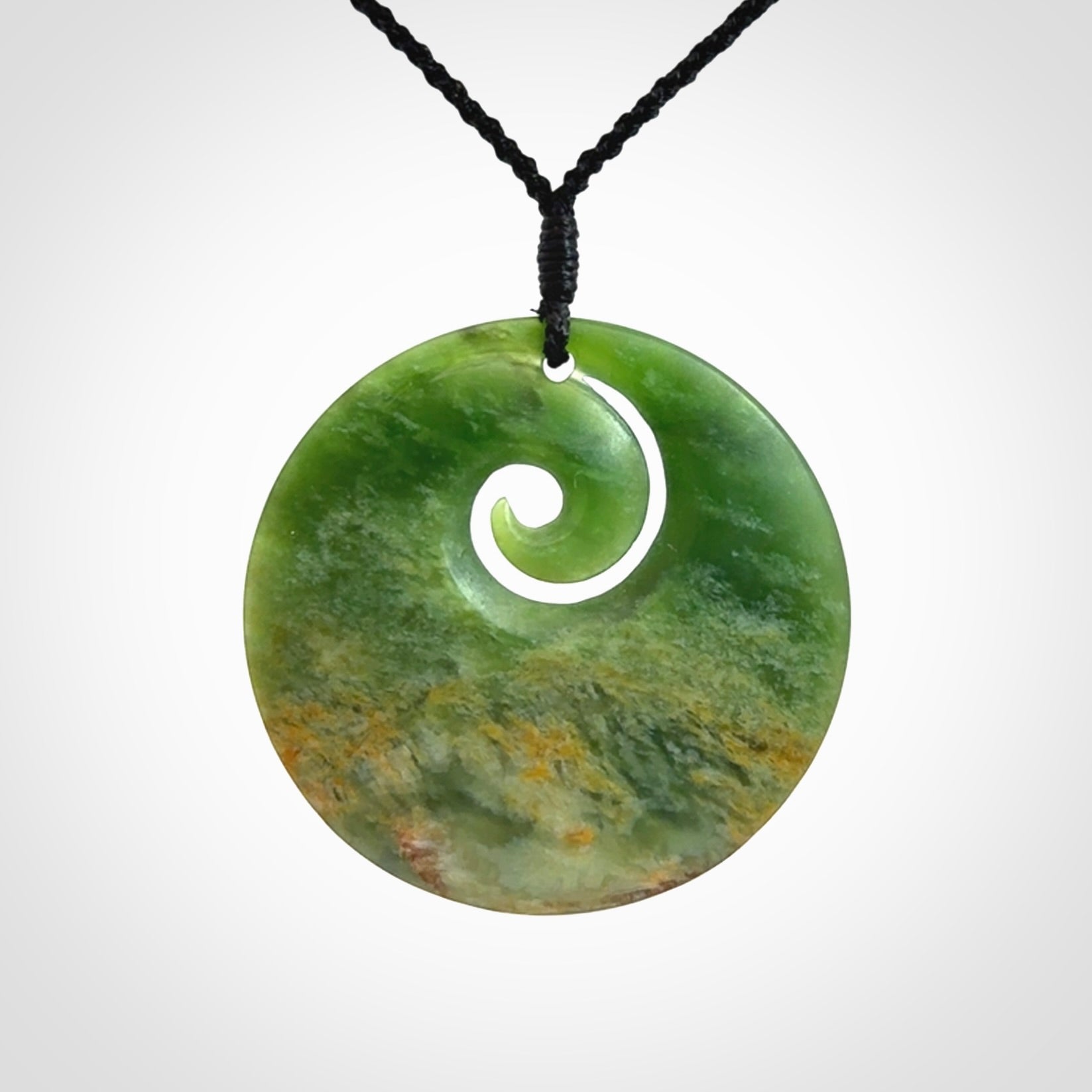 Hand carved New Zealand Flower Jade koru pendant