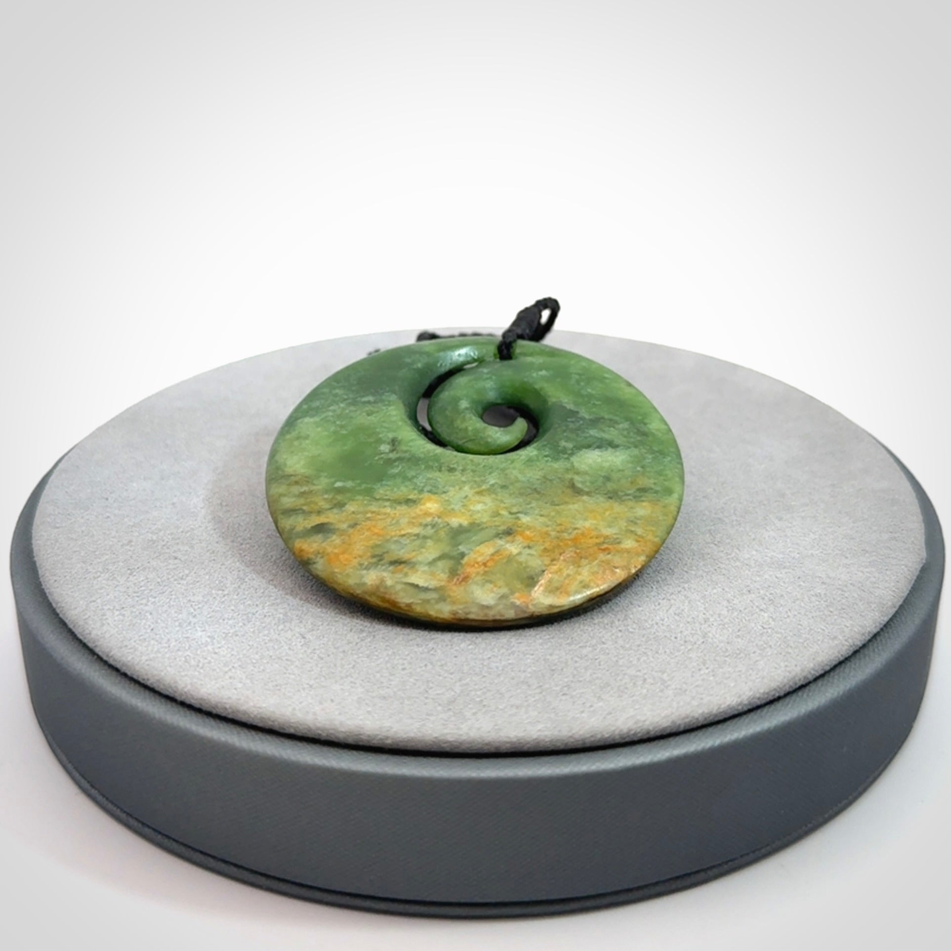 Hand carved New Zealand Flower Jade koru pendant