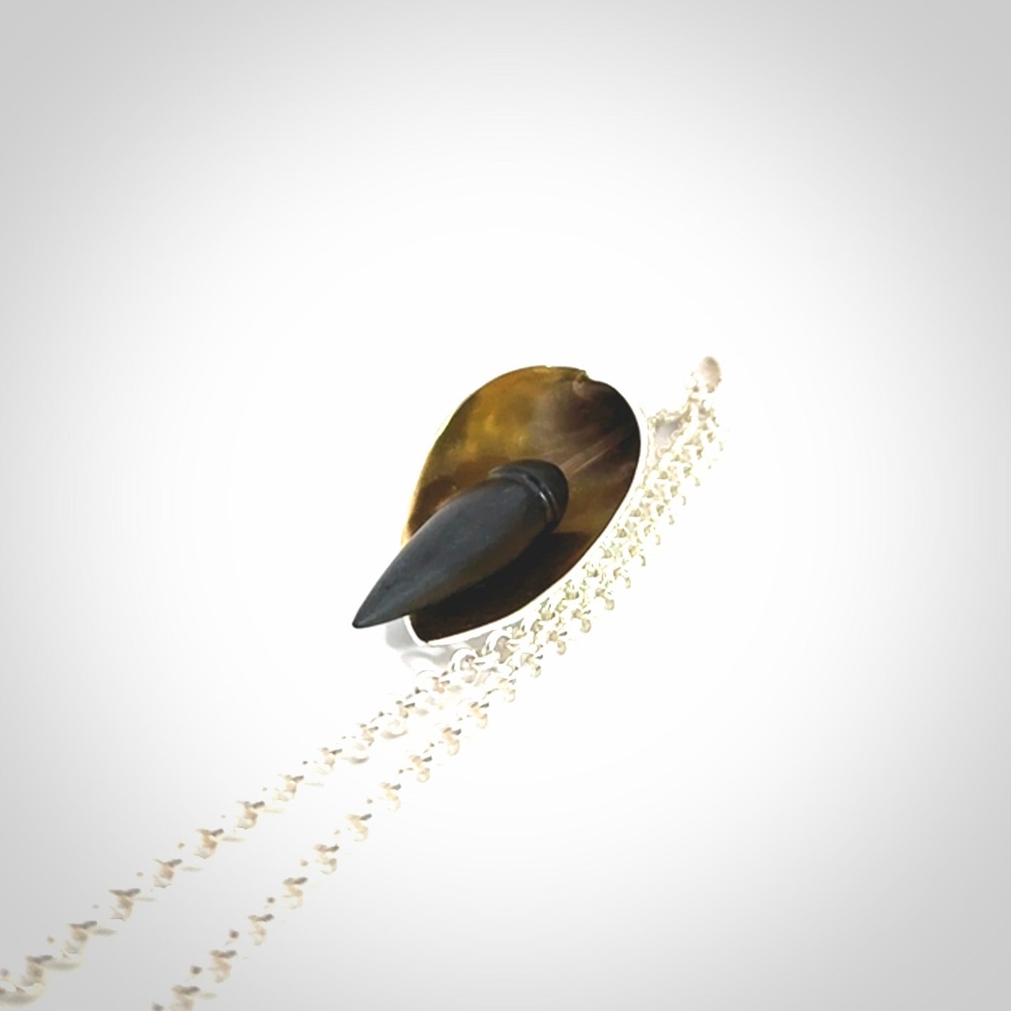 Sterling Silver drop pendant with Black Jade centre and Gold Plated interior. Provided with a sterling silver chain.