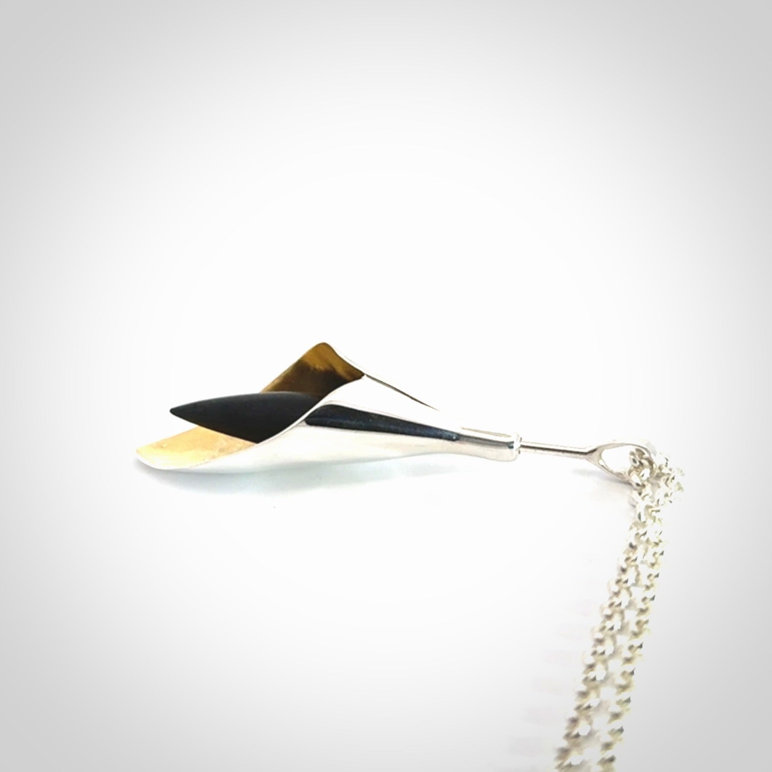 Sterling Silver drop pendant with Black Jade centre and Gold Plated interior. Provided with a sterling silver chain.