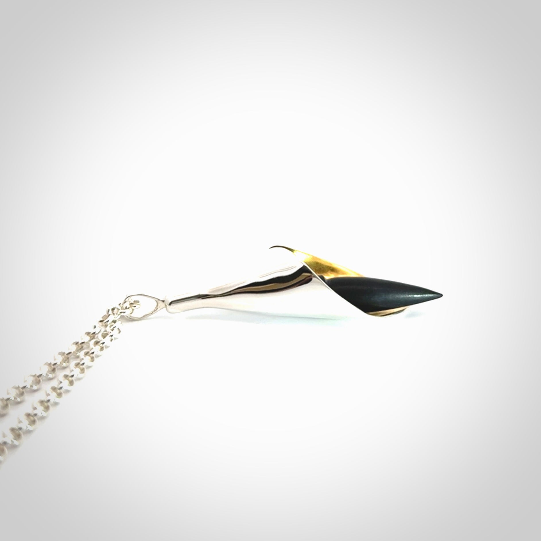 Sterling Silver drop pendant with Black Jade centre and Gold Plated interior. Provided with a sterling silver chain.