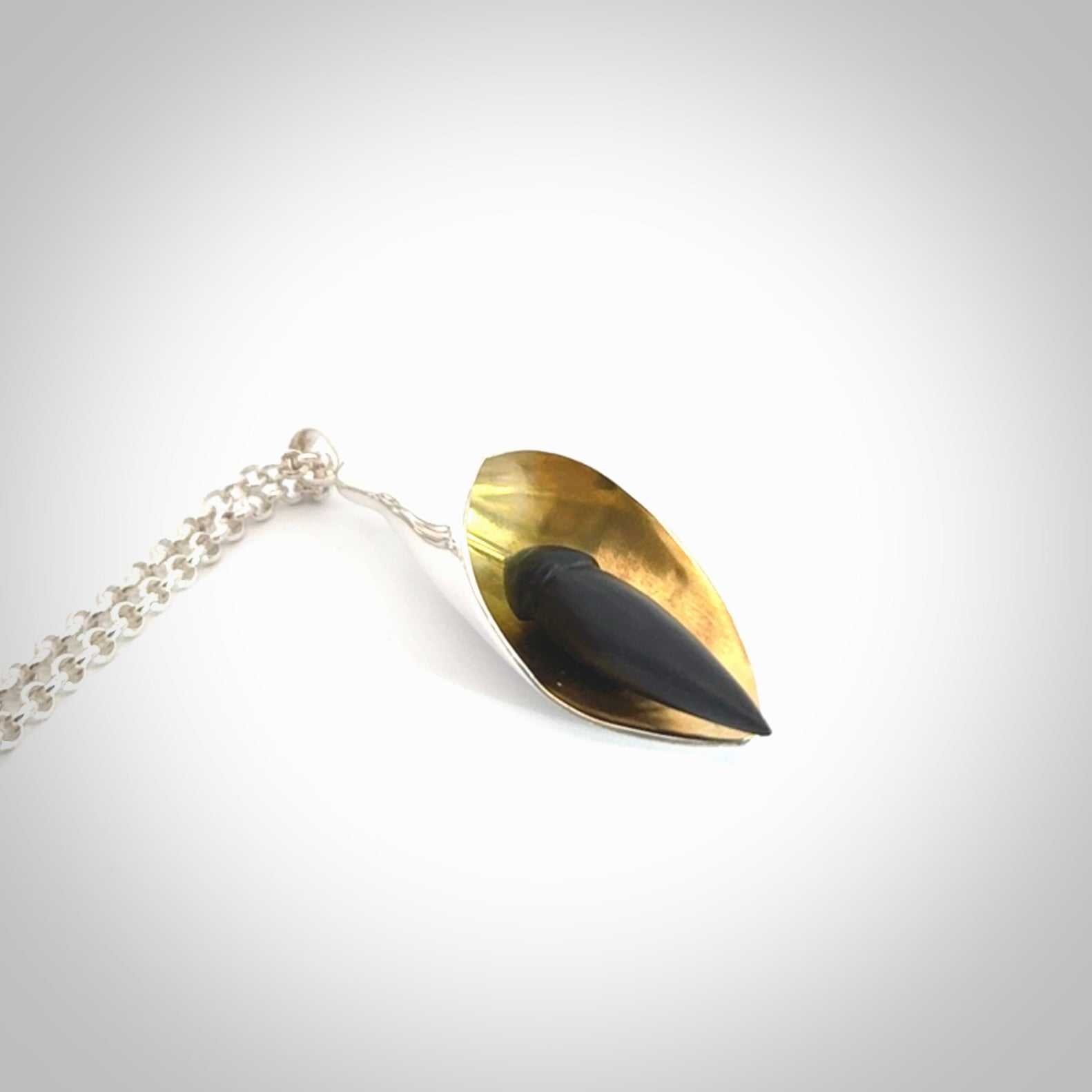 Sterling Silver drop pendant with Black Jade centre and Gold Plated interior. Provided with a sterling silver chain.