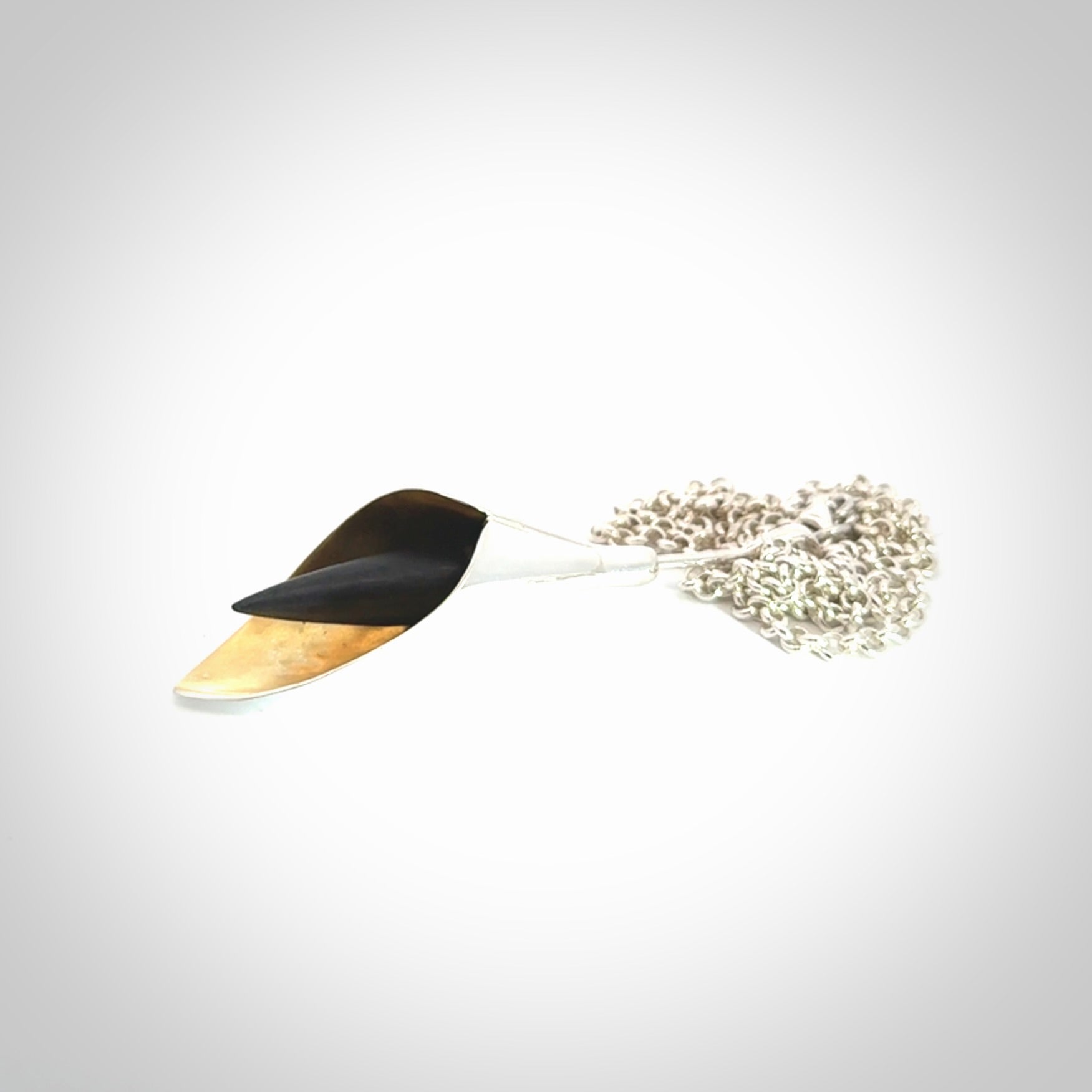 Sterling Silver drop pendant with Black Jade centre and Gold Plated interior. Provided with a sterling silver chain.