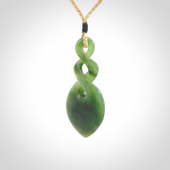 Hand carved New Zealand jade twist pendant. Carved in New Zealand by NZ Pacific. Unique double twist jewellery for sale online. Provided with an adjustable oat cord.