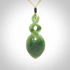 Hand carved New Zealand jade twist pendant. Carved in New Zealand by NZ Pacific. Unique double twist jewellery for sale online. Provided with an adjustable oat cord.