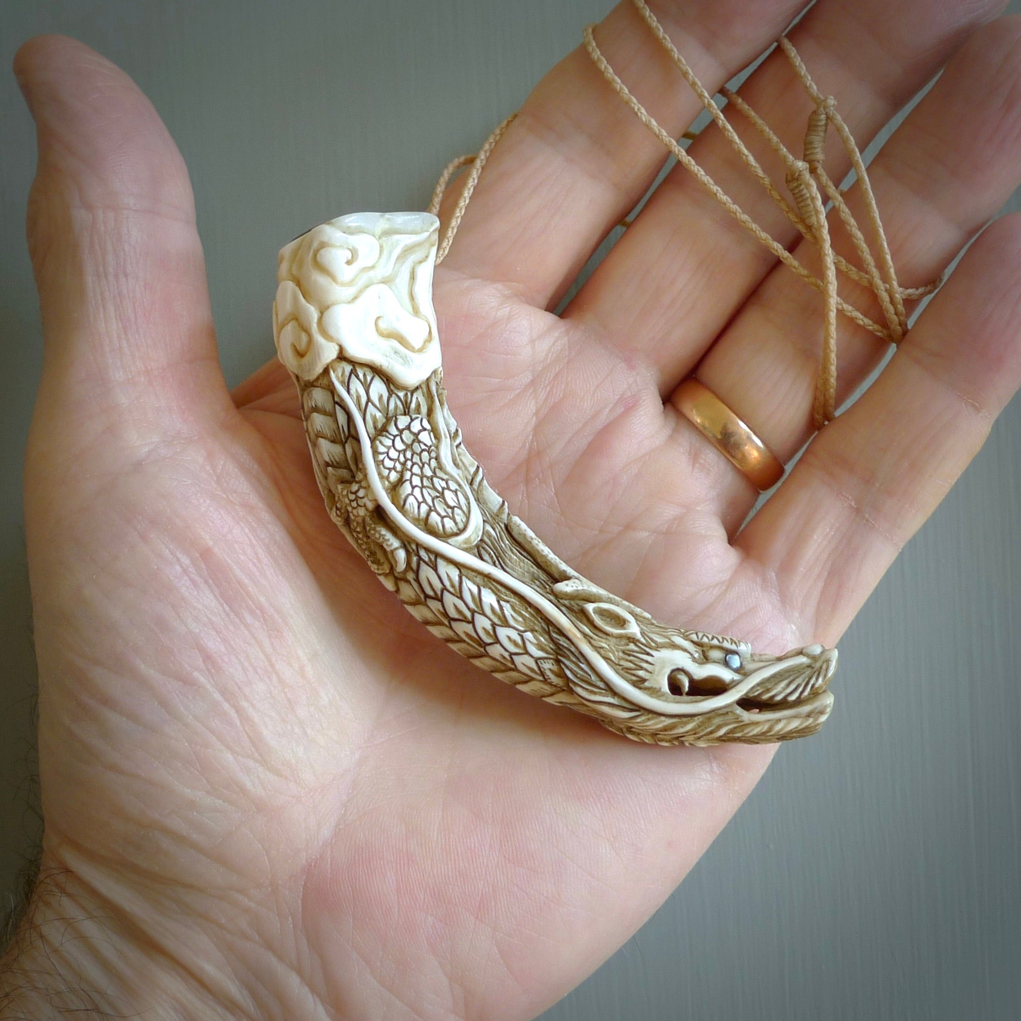 Hand carved dragon Pendant. Made from warthog tusk in New Zealand. Unique dragon necklace hand made from warthog tusk by master bone carver Fumio Noguchi. Spectacular collectable work of art, made to wear. One only pendant, delivered to you at no extra cost with express courier.