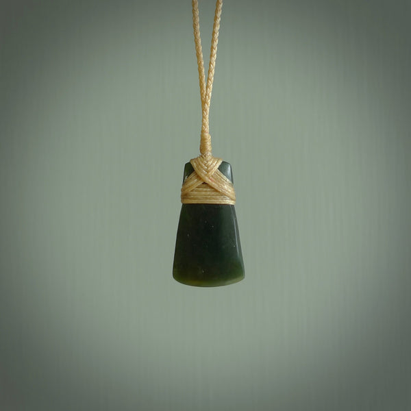 Hand carved jade toki by Ric Moor. Made in New Zealand by NZ Pacific. Hand carved Toki pendants crafted from beautiful New Zealand Pounamu, Jade. We deliver these with Express Courier, on adjustable cords.