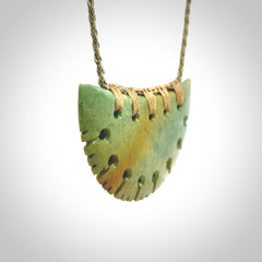 Hand carved New Zealand Flower Jade half-shield pendant.