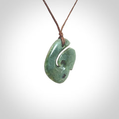A lovely jade koru pendant