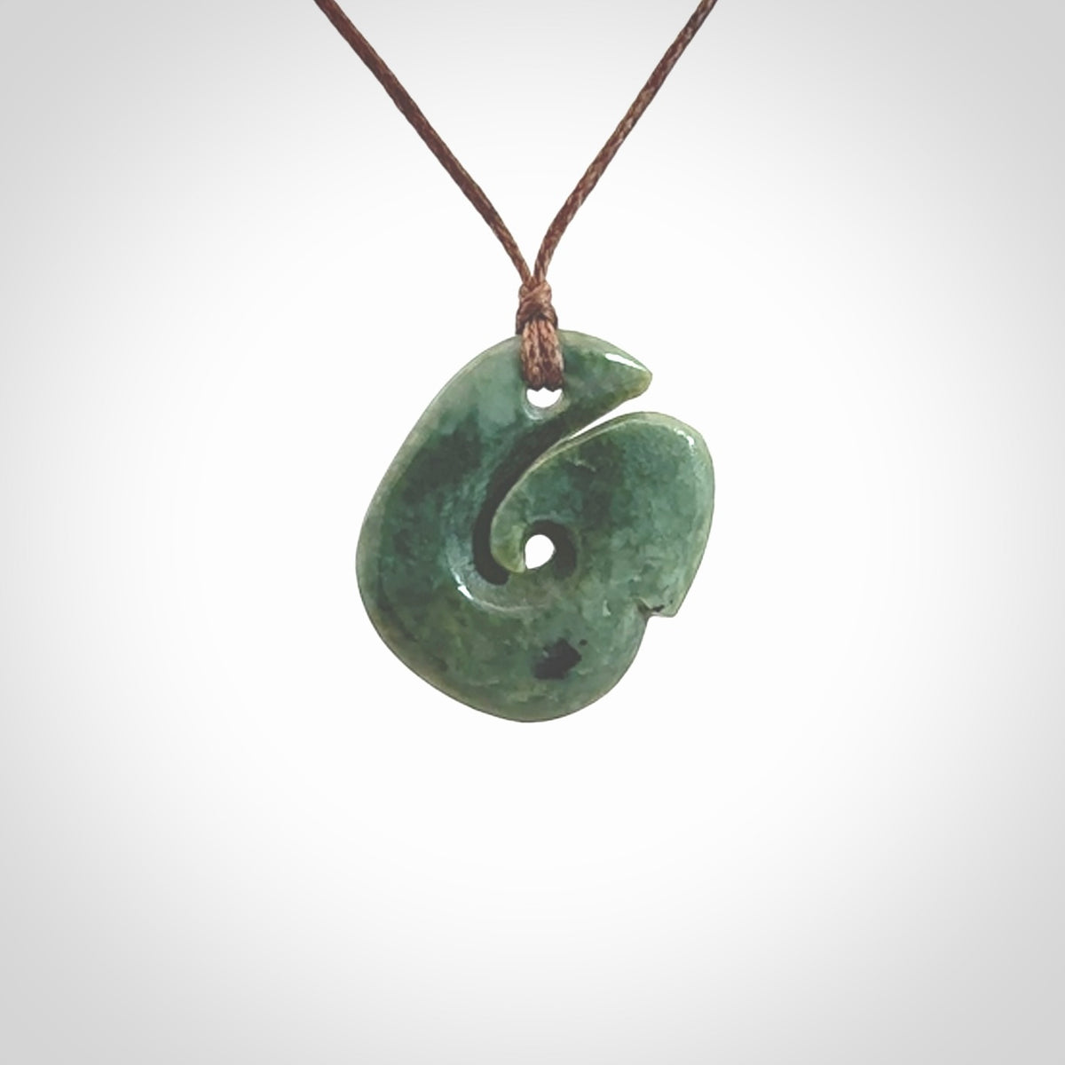 A lovely jade koru pendant