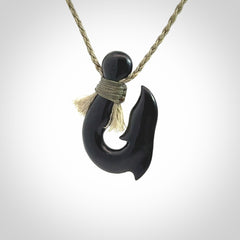 These pendants are hand carved, black jade hooks or matau pendants. They are beautifully finished in a high polish and bound with a khaki necklace cord.
